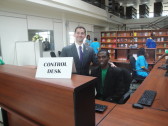 One of our Kigali Public Library staff members working at the front desk.