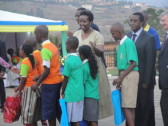 Rwanda's First Lady Jeannette Kagame, U.S. Ambassador to Rwanda Don Koran, and other dignitaries hand out awards to Rwandan schoolchildren who distinguished themselves during Rwanda's annual "Reading Week."